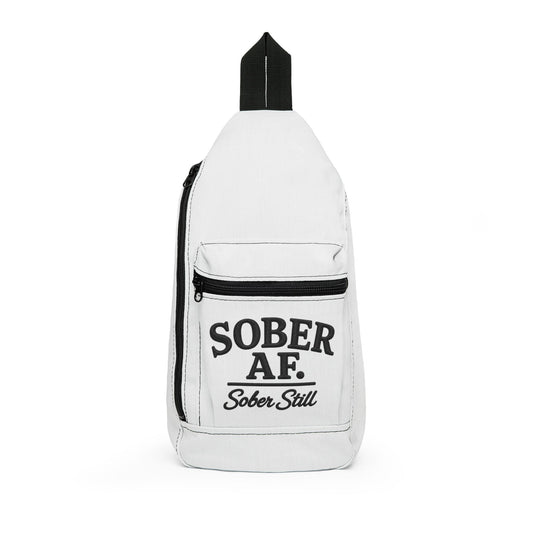 Cream sling bag with "SOBER AF" embroidered across the front pocket and "Sober Still" on the strap